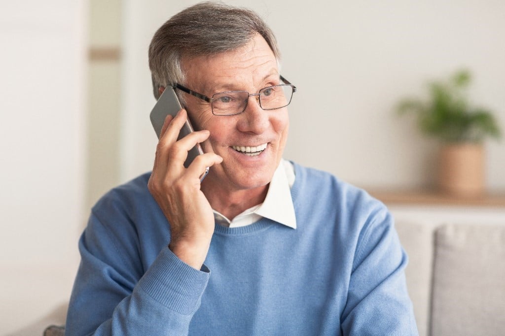 A person wearing glasses talking on a cell phone

Description automatically generated